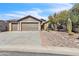 Charming home featuring a three-car garage, stone accents, and a well-maintained desert landscape at 6792 W Willow Way, Florence, AZ 85132