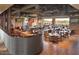 Brightly lit restaurant dining area featuring a large open space, wood tables and exposed ductwork at 6792 W Willow Way, Florence, AZ 85132