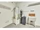 Utility room with water heater, water softener, shelving, and sink at 6792 W Willow Way, Florence, AZ 85132