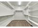 Spacious walk-in closet with shelving, rods, and carpeted floor at 6792 W Willow Way, Florence, AZ 85132