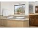 Luxurious bathroom featuring a modern soaking tub with views of the desert landscape at 7603 E Soaring Eagle Way, Scottsdale, AZ 85266