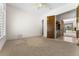 Bedroom area features a bar, custom wood cabinets, access to office, and neutral carpeting at 7603 E Soaring Eagle Way, Scottsdale, AZ 85266