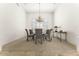 Formal dining room with modern chandelier and neutral decor at 7603 E Soaring Eagle Way, Scottsdale, AZ 85266