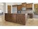 Spacious kitchen with stainless steel appliances and dark wood cabinets at 7603 E Soaring Eagle Way, Scottsdale, AZ 85266