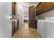 Laundry room with white appliances and wooden cabinets at 7603 E Soaring Eagle Way, Scottsdale, AZ 85266