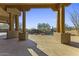 Covered patio overlooking a pool with a waterfall and desert scenery at 7603 E Soaring Eagle Way, Scottsdale, AZ 85266