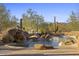 Beautiful pool with a waterfall feature, surrounded by desert landscaping at 7603 E Soaring Eagle Way, Scottsdale, AZ 85266