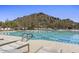 Community pool surrounded by lounge chairs and stunning desert mountain views at 7603 E Soaring Eagle Way, Scottsdale, AZ 85266