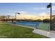 Tennis court features grass surrounding and desert landscape views at 7603 E Soaring Eagle Way, Scottsdale, AZ 85266
