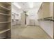 Large walk-in closet with built in shelving, lighting, and plush carpeting at 7603 E Soaring Eagle Way, Scottsdale, AZ 85266