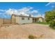 View of the backyard, showing the play structure, back of home and surrounding wall at 7605 W Avalon Dr, Phoenix, AZ 85033