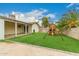This backyard features a grass area with playset and a covered patio at 7605 W Avalon Dr, Phoenix, AZ 85033