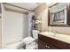 Bathroom featuring a tiled shower and a mirrored vanity with ample storage at 7605 W Avalon Dr, Phoenix, AZ 85033