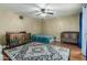Spacious bedroom with wood floors, a ceiling fan and two cribs at 7605 W Avalon Dr, Phoenix, AZ 85033