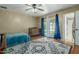 Bright bedroom features a ceiling fan and access to a full bathroom at 7605 W Avalon Dr, Phoenix, AZ 85033