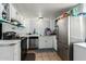 Bright kitchen features a stainless steel refrigerator and updated appliances at 7605 W Avalon Dr, Phoenix, AZ 85033