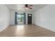 Inviting living room with tile floors, large window with blue curtains, and decorative front door at 7605 W Avalon Dr, Phoenix, AZ 85033