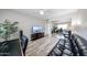 This bedroom has modern wood floors, a large sliding door closet, and a cozy sitting area with a couch and a ceiling fan at 7860 E Camelback Rd # 309, Scottsdale, AZ 85251