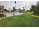 Picturesque golf course features a pond with a fountain and palm trees in the background at 7860 E Camelback Rd # 309, Scottsdale, AZ 85251