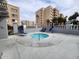 Inviting hot tub surrounded by lounge chairs on a private patio is perfect for relaxation at 7860 E Camelback Rd # 309, Scottsdale, AZ 85251