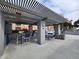 Outdoor kitchen and dining area featuring built-in grills, sink, and stylish seating at 7860 E Camelback Rd # 309, Scottsdale, AZ 85251