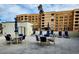 Community pool and patio area with ample seating, umbrellas, and lush landscaping at 7860 E Camelback Rd # 309, Scottsdale, AZ 85251