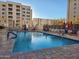Community pool area featuring lounge chairs, tables, and a refreshing swimming pool at 7860 E Camelback Rd # 309, Scottsdale, AZ 85251
