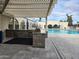 Enjoy the pool and outdoor kitchen area, featuring a grill and comfortable seating at 7860 E Camelback Rd # 309, Scottsdale, AZ 85251