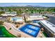 An aerial shot showcasing community amenities including a pool, tennis and pickleball courts, and mountain views at 805 S 82Nd Pl, Mesa, AZ 85208