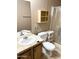 A bathroom featuring a sink, toilet with storage shelves, and glass-enclosed shower at 805 S 82Nd Pl, Mesa, AZ 85208