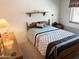 Comfortable bedroom featuring a full bed, bedside tables and lamps and a full window at 805 S 82Nd Pl, Mesa, AZ 85208