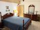 A well-lit bedroom features a wooden bed frame and matching dresser with mirror at 805 S 82Nd Pl, Mesa, AZ 85208