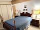 Cozy bedroom with a blue quilt, matching nightstands, and ample closet space at 805 S 82Nd Pl, Mesa, AZ 85208