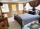 This bedroom features wood paneling, neutral carpet and a full-sized bed at 805 S 82Nd Pl, Mesa, AZ 85208