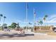 Veterans Memorial landmark with fountain and flagpoles, set against a clear blue sky and palm tree scenery at 805 S 82Nd Pl, Mesa, AZ 85208