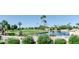 Scenic view of lush golf course, sparkling community lake, and mature palm trees at 805 S 82Nd Pl, Mesa, AZ 85208