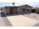 Charming home featuring desert landscaping, mature palm trees, and a covered front porch at 805 S 82Nd Pl, Mesa, AZ 85208