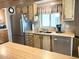 A spacious kitchen features stainless steel appliances, wood cabinets, and ample counter space at 805 S 82Nd Pl, Mesa, AZ 85208