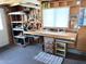 Functional workshop space featuring a workbench, storage, and natural light from a window at 805 S 82Nd Pl, Mesa, AZ 85208
