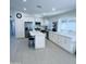 Bright kitchen featuring white cabinetry, stainless steel appliances, island and tile floors at 8837 W Coolidge St, Phoenix, AZ 85037