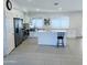 Bright kitchen featuring white cabinetry, stainless steel appliances, island and tile floors at 8837 W Coolidge St, Phoenix, AZ 85037