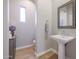 Cozy half-bath with a pedestal sink, a framed mirror, and light-colored walls at 9096 E Mountain Spring Rd, Scottsdale, AZ 85255