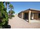Cozy backyard with a covered patio, gravel landscaping, and privacy trees at 9763 W Butler Dr, Peoria, AZ 85345
