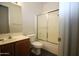 Bathroom with single sink vanity, tile floor, and shower-tub combination at 9763 W Butler Dr, Peoria, AZ 85345