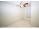 Neutral bedroom with plush carpet, fan, and window offering lots of light at 9763 W Butler Dr, Peoria, AZ 85345