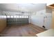 Two car garage with storage cabinets and mounted tool rack at 9763 W Butler Dr, Peoria, AZ 85345
