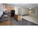 Open concept kitchen with an island, wood cabinets, and black appliances at 9763 W Butler Dr, Peoria, AZ 85345