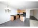 Open concept kitchen with an island, wood cabinets, and black appliances at 9763 W Butler Dr, Peoria, AZ 85345