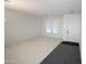 Bright living room featuring large windows, neutral carpet, and white walls at 9763 W Butler Dr, Peoria, AZ 85345