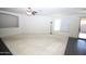 Bright living room with neutral tones, ceiling fan, tile accents, and sliding door access at 9763 W Butler Dr, Peoria, AZ 85345
